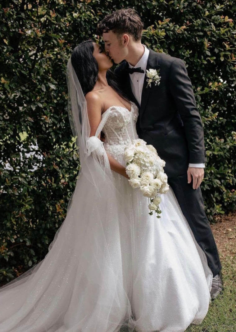 Сouple wearing a white gown and a black suit
